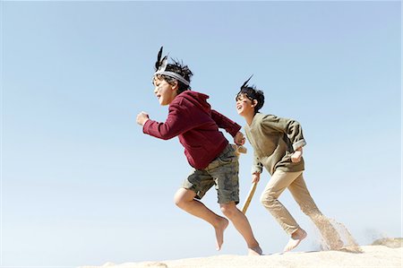 simsearch:649-07761212,k - Two boys, wearing fancy dress, playing on sand Stock Photo - Premium Royalty-Free, Code: 649-08144215