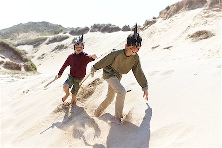 simsearch:649-07761212,k - Two boys, wearing fancy dress, playing on sand Stock Photo - Premium Royalty-Free, Code: 649-08144213