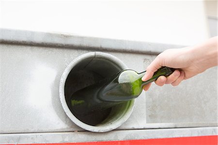 disposal - Person recycling wine bottle in bottle bank Stock Photo - Premium Royalty-Free, Code: 649-08144294