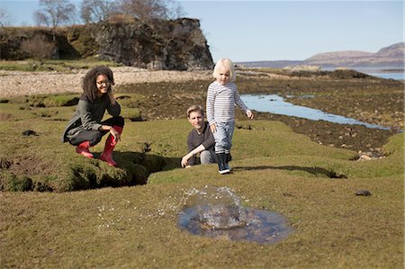 Boy throwing rock into puddle, Isle of Skye, Hebrides, Scotland Stock Photo - Premium Royalty-Free, Code: 649-08144427