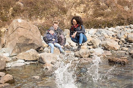Family throwing stones in pond, Fairy Pools, Isle of Skye, Hebrides, Scotland Stock Photo - Premium Royalty-Free, Code: 649-08144539
