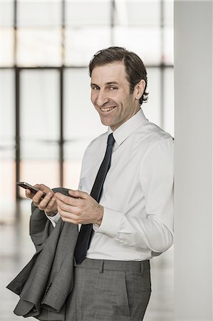 simsearch:649-07520071,k - Portrait of mature businessman, using smartphone, smiling Stock Photo - Premium Royalty-Free, Code: 649-08144661