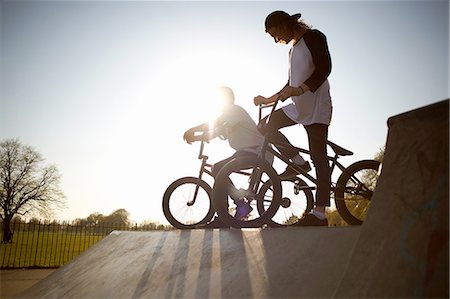 Two young men on bmx bikes at skatepark Stock Photo - Premium Royalty-Free, Code: 649-08144675