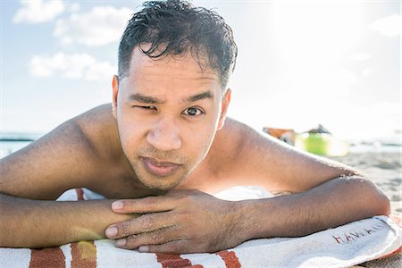 Portrait of young man sunbathing on Waikiki Beach, Hawaii, USA Stock Photo - Premium Royalty-Free, Code: 649-08145043