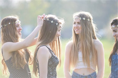 simsearch:649-07520254,k - Teenage girls putting on and wearing daisy chain headdresses in park Stock Photo - Premium Royalty-Free, Code: 649-08145174