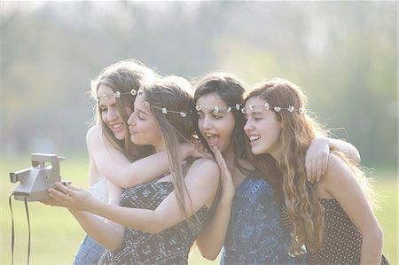 simsearch:649-07520254,k - Four teenage girls in park  taking instant camera selfie Stock Photo - Premium Royalty-Free, Code: 649-08145183
