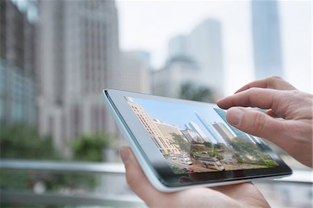 Man using digital tablet, focus on hands, Hong Kong, China Stock Photo - Premium Royalty-Free, Code: 649-08145405