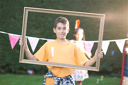 simsearch:649-06845253,k - Portrait of boy looking through picture frame, looking at camera Stock Photo - Premium Royalty-Free, Code: 649-08179759