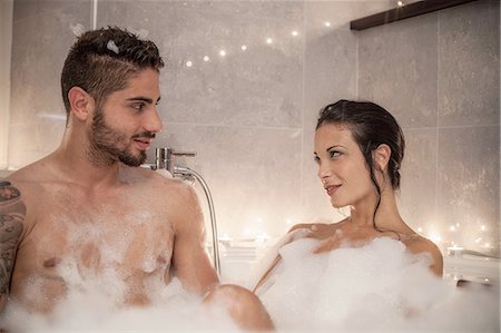 Young couple gazing at each other in bubble bath Stock Photo - Premium Royalty-Free, Code: 649-08179960