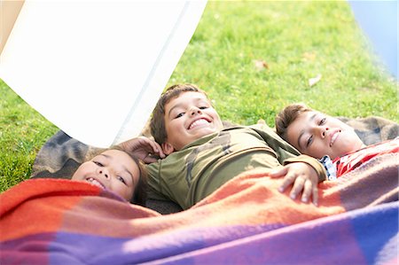 simsearch:614-07806393,k - Girl and two brothers lying in garden wrapped in blanket Stock Photo - Premium Royalty-Free, Code: 649-08180227
