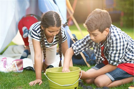 simsearch:614-08270379,k - Boy and sister preparing bucket for campfire in garden Stock Photo - Premium Royalty-Free, Code: 649-08180231