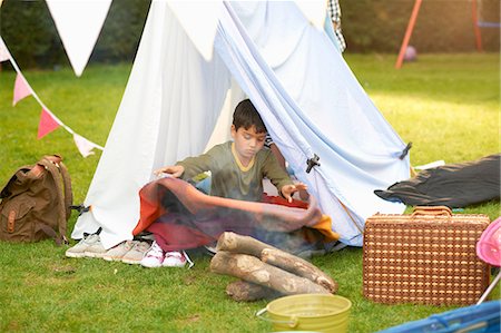 simsearch:649-08180244,k - Boy shaking blanket from homemade tent in garden Stock Photo - Premium Royalty-Free, Code: 649-08180233