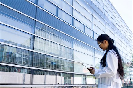 simsearch:649-07585094,k - Young female scientist looking at digital tablet outside laboratory Stock Photo - Premium Royalty-Free, Code: 649-08180584