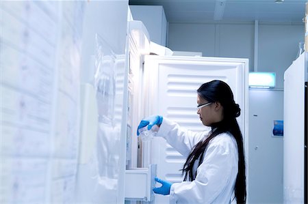 simsearch:649-08085222,k - Female scientist selecting refrigerated sample in laboratory Stock Photo - Premium Royalty-Free, Code: 649-08180587