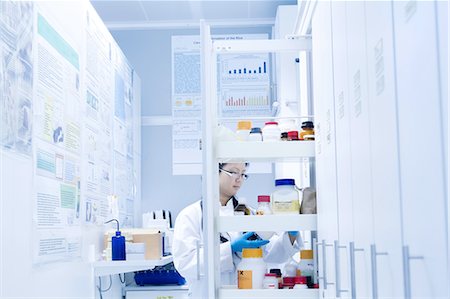 simsearch:649-08085222,k - Female scientist selecting specimen jar from shelves in laboratory Stock Photo - Premium Royalty-Free, Code: 649-08180588