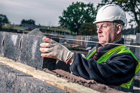 single brick - Workers laying bricks on construction site Stock Photo - Premium Royalty-Free, Code: 649-08238234