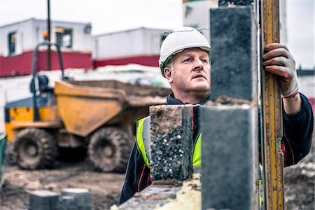 Workers laying bricks on construction site Stock Photo - Premium Royalty-Free, Code: 649-08238231