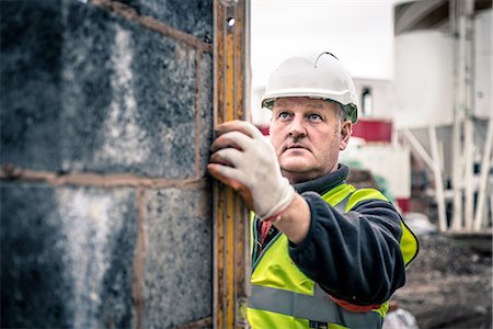 Workers laying bricks on construction site Stock Photo - Premium Royalty-Free, Code: 649-08238232