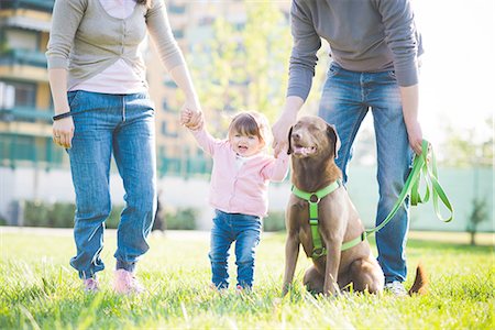 Mid adult couple holding hands with toddler daughter in park Stock Photo - Premium Royalty-Free, Code: 649-08238424