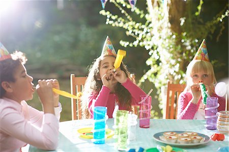 simsearch:649-07804176,k - Boy and girls blowing party horns at garden birthday party Stock Photo - Premium Royalty-Free, Code: 649-08238519