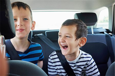 Two happy young brothers traveling in car back seat Stock Photo - Premium Royalty-Free, Code: 649-08238533