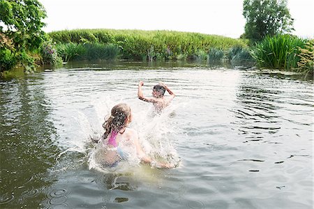 simsearch:614-08270379,k - Teenage boy and sister splashing in rural lake Stock Photo - Premium Royalty-Free, Code: 649-08238765
