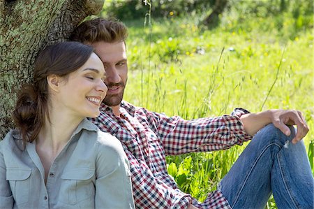 simsearch:649-08239088,k - Young couple sitting leaning against tree together Stock Photo - Premium Royalty-Free, Code: 649-08239063