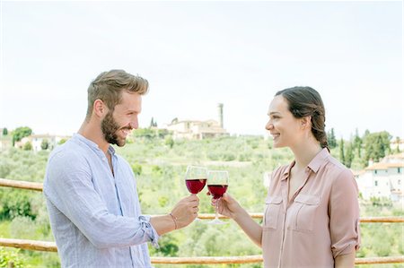 simsearch:649-08239088,k - Waist up side view of young couple face to face making a toast smiling Stock Photo - Premium Royalty-Free, Code: 649-08239103
