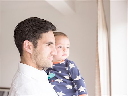 simsearch:649-07437107,k - Father and young son looking out of window Stock Photo - Premium Royalty-Free, Code: 649-08232498