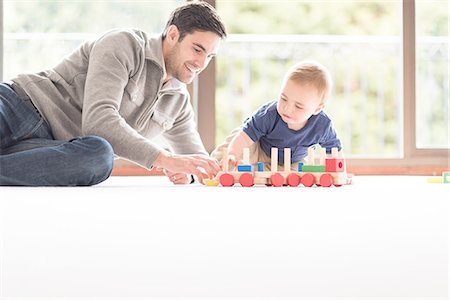 floor - Father and young son playing together, indoors Stock Photo - Premium Royalty-Free, Code: 649-08232501