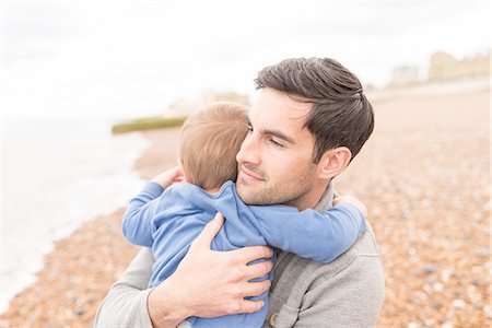 simsearch:649-07437107,k - Father hugging young son on pebble beach Stock Photo - Premium Royalty-Free, Code: 649-08232517
