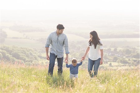 simsearch:649-07437107,k - Young family walking in field, hand in hand Stock Photo - Premium Royalty-Free, Code: 649-08232512