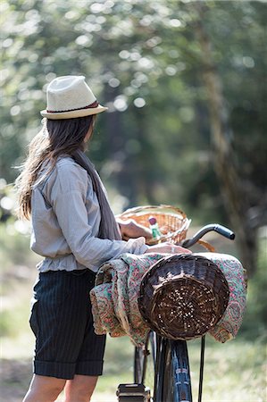 simsearch:649-08900720,k - Mature woman looking out to forest with bicycle and foraging baskets Stock Photo - Premium Royalty-Free, Code: 649-08232804