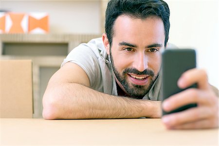 simsearch:649-06845199,k - Young male designer reading smartphone texts at boardroom table Stock Photo - Premium Royalty-Free, Code: 649-08306339