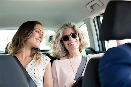 family inside car - Two women chatting in back seat of car Stock Photo - Premium Royalty-Free, Code: 649-08306371