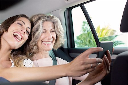 family inside car - Senior woman and daughter taking smartphone selfie in car Stock Photo - Premium Royalty-Free, Code: 649-08306373