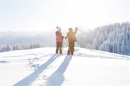 Senior couple on snow covered landscape holding walking poles looking away, Sattelbergalm, Tyrol, Austria Stock Photo - Premium Royalty-Free, Code: 649-08306437