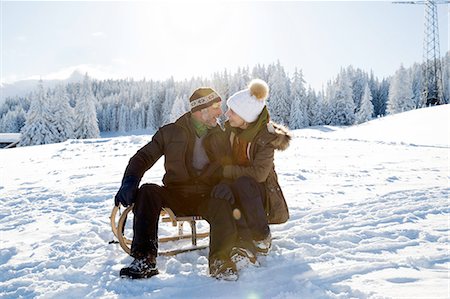 simsearch:649-07438003,k - Senior couple on snowy landscape sitting on sledge face to face smiling, Sattelbergalm, Tyrol, Austria Stock Photo - Premium Royalty-Free, Code: 649-08306448