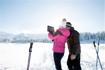 simsearch:649-07438003,k - Rear view of senior couple on snowy landscape using digital tablet to take photograph of mountain range, Sattelbergalm, Tyrol, Austria Stock Photo - Premium Royalty-Free, Code: 649-08306442