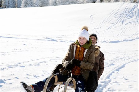 simsearch:649-07438003,k - Senior couple sitting on sledge looking at camera smiling, Sattelbergalm, Tyrol, Austria Stock Photo - Premium Royalty-Free, Code: 649-08306443