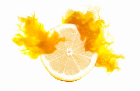 Half a lemon with corresponding coloured digital burst effect Stock Photo - Premium Royalty-Free, Code: 649-08306843