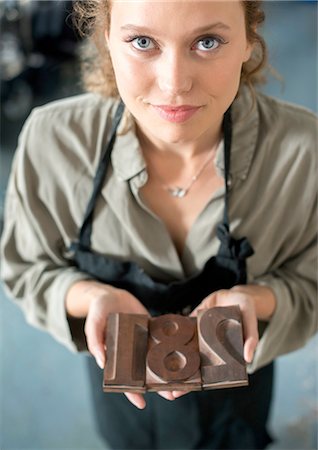 female artisan - Woman holding traditional letterpress numerals workshop Stock Photo - Premium Royalty-Free, Code: 649-08307045