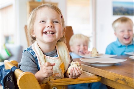 simsearch:614-07806393,k - Three young children eating cake at tea table Stock Photo - Premium Royalty-Free, Code: 649-08307459