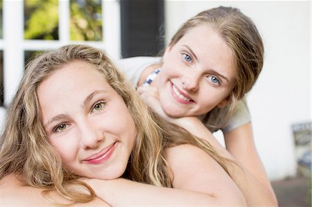 simsearch:649-07520254,k - Portrait of two teenage girls lying on patio Stock Photo - Premium Royalty-Free, Code: 649-08307525