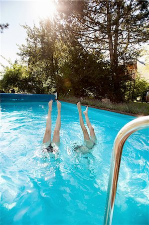 Two teenage girls diving into swimming pool Stock Photo - Premium Royalty-Free, Code: 649-08307531