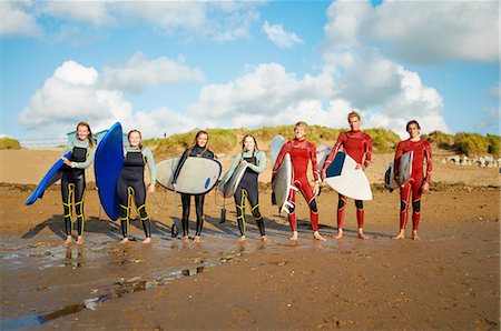 Group of surfers, standing on beach, holding surfboards Stock Photo - Premium Royalty-Free, Code: 649-08327892