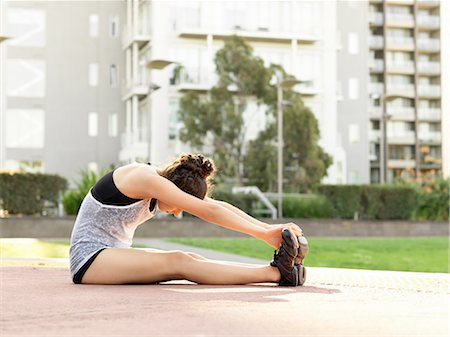 Young woman stretching in park Stock Photo - Premium Royalty-Free, Code: 649-08328301