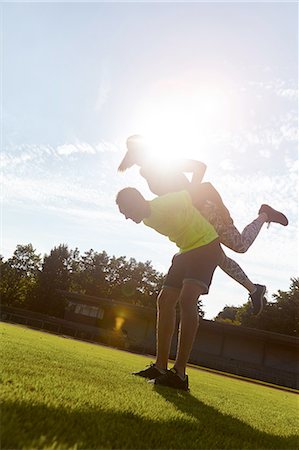 Young woman and man fooling around whilst training in park Stock Photo - Premium Royalty-Free, Code: 649-08328415