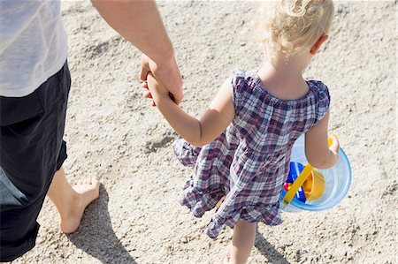 simsearch:649-07761212,k - Father and female toddler strolling on beach with toy bucket Stock Photo - Premium Royalty-Free, Code: 649-08328713
