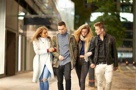 people walking in the street - Two young couples strolling arm in arm on street at night, London, UK Stock Photo - Premium Royalty-Free, Code: 649-08328957